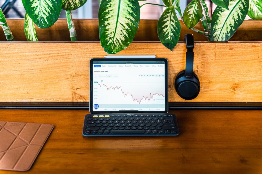 a laptop computer sitting on top of a wooden desk